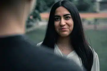 woman in black blazer smiling