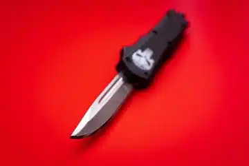 black and silver knife on red surface