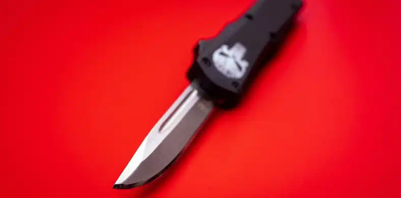 black and silver knife on red surface